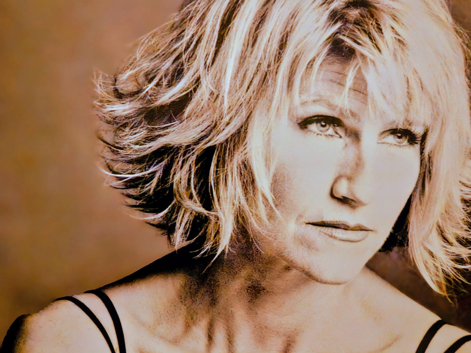 Close-up portrait of blonde woman in warm tones